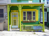 Porch is painted in yellow and green