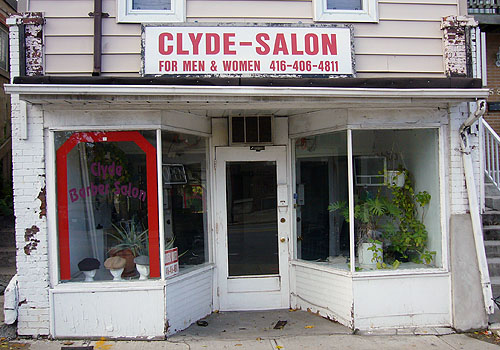 Dilapidated storefront has sign reading CLYDE SALON