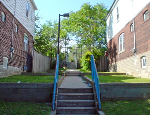 Walkway with stairs leading to lawn leading to more stairs