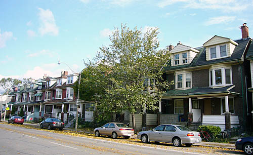 Nearly identical row houses with gabled roofs