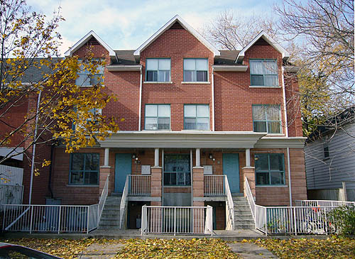 Three-storey red-brick building with basements has peaked roofs