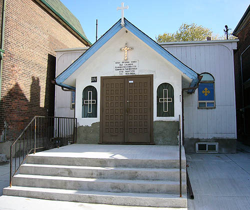 Tiny Greek Orthodox church is one storey high and has a deep but short concrete staircase and landing