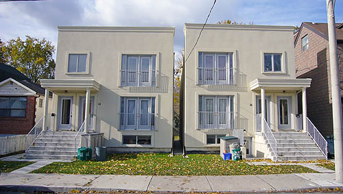 Squarish duplexes with Juliet balconies finished in bright cream colour