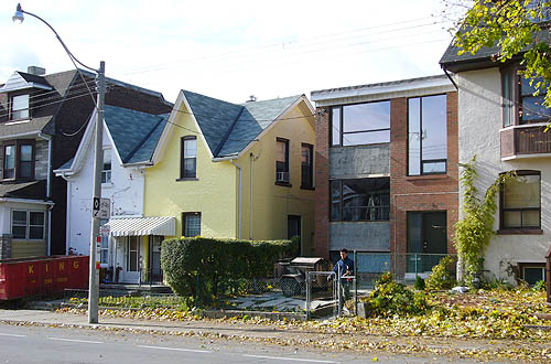 Three-storey brick house; white and yellow plaster semi-detached houses; two-storey rectangular apartment building