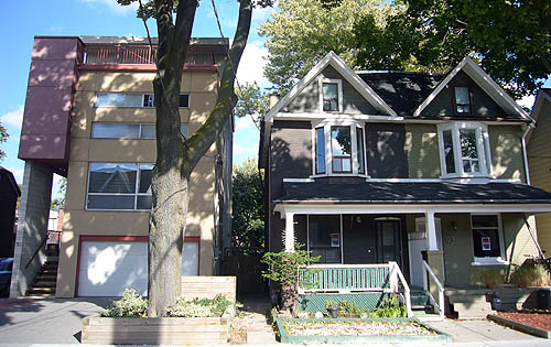 Giant Modernist house alongside two identical semidetached houses with gables, front porches, and second-floor bay windows